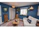 Bright living room features natural light, hardwood floors, and a cozy seating arrangement at 8229 Estes Ct, Arvada, CO 80005