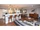 Bright, open-concept living space with a modern kitchen, dining area, and comfortable seating at 8229 Estes Ct, Arvada, CO 80005