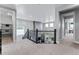 Spacious foyer featuring an open staircase, contemporary lighting, and views into the living spaces below at 16320 W 92Nd Cir, Arvada, CO 80007