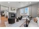 Inviting living room with fireplace, modern seating, and seamless flow to the dining area creating an open and airy space at 16320 W 92Nd Cir, Arvada, CO 80007