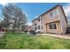 Lush backyard with a patio area, mature trees, and well-kept lawn at 2649 S Kline Cir, Lakewood, CO 80227