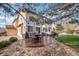 Backyard with a patio, outdoor dining, well-maintained landscaping, and mature trees at 2649 S Kline Cir, Lakewood, CO 80227