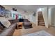 Finished basement featuring a comfortable seating area, workout space, and staircase at 2649 S Kline Cir, Lakewood, CO 80227
