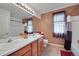 Well-lit bathroom featuring a double vanity, neutral tones, and a shower/tub combination at 2649 S Kline Cir, Lakewood, CO 80227