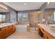 Stylish bathroom with a large soaking tub, glass shower, and double vanity at 2649 S Kline Cir, Lakewood, CO 80227