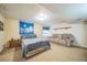 Spacious bedroom with a full bed, soft sofa, neutral walls, and comfortable carpet at 2649 S Kline Cir, Lakewood, CO 80227