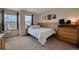 Comfortable bedroom with natural light, a dresser, and simple decor at 2649 S Kline Cir, Lakewood, CO 80227