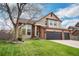 Charming two-story home with manicured lawn and mature tree in a well-kept front yard at 2649 S Kline Cir, Lakewood, CO 80227