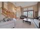 Open living room with high ceilings, many windows, and neutral tones at 2649 S Kline Cir, Lakewood, CO 80227