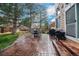 Back patio featuring outdoor dining furniture, a grill, and beautiful landscaping at 2649 S Kline Cir, Lakewood, CO 80227