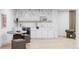 Chic bar area with white cabinetry, wine fridge, and stylish decor at 11825 W 25Th Ave, Lakewood, CO 80215