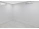 Bright basement space featuring neutral carpet, white walls, and small windows at 11825 W 25Th Ave, Lakewood, CO 80215