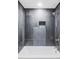 Bathroom with gray tiled shower, shower niche, and gold fixtures at 11825 W 25Th Ave, Lakewood, CO 80215