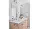 Bright bathroom featuring double sink vanity with modern fixtures and stylish lighting at 11825 W 25Th Ave, Lakewood, CO 80215