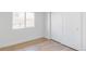Bedroom with hardwood floors, a window and closet with sliding doors at 11825 W 25Th Ave, Lakewood, CO 80215