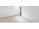 White bedroom with neutral carpet, white walls, and window at 11825 W 25Th Ave, Lakewood, CO 80215