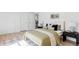 Comfortable bedroom with a bed, modern furniture, and a view into the hallway and kitchen at 11825 W 25Th Ave, Lakewood, CO 80215