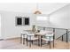 Modern dining room with a stylish table, four chairs, and modern lighting at 11825 W 25Th Ave, Lakewood, CO 80215