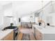 Open-concept kitchen with modern appliances, a spacious island, and an adjacent dining area at 11825 W 25Th Ave, Lakewood, CO 80215
