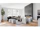 Bright living room with a modern fireplace, neutral furnishings, and large windows at 11825 W 25Th Ave, Lakewood, CO 80215