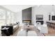 Bright living room featuring a modern fireplace, hardwood floors, and stylish contemporary furnishings at 11825 W 25Th Ave, Lakewood, CO 80215