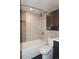 Updated bathroom with a tiled shower-over-tub and dark wood cabinetry at 12033 E Harvard Ave # 208, Aurora, CO 80014