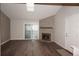 Bright living room with a stone fireplace, wood beam, and sliding glass doors at 12033 E Harvard Ave # 208, Aurora, CO 80014