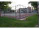 Outdoor tennis court surrounded by a chain-link fence at 12033 E Harvard Ave # 208, Aurora, CO 80014