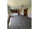 Open-concept living room with carpeting, ceiling fan and view to kitchen area at 1062 Timbervale Trl, Highlands Ranch, CO 80129