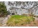 Lush backyard with green lawn, wooden bridge, and mature trees, offering a private outdoor retreat at 1011 S Valentia St # 147, Denver, CO 80247