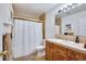 Well-lit bathroom featuring a vanity with cabinets, a shower with gold trim and a built-in medicine cabinet at 1011 S Valentia St # 147, Denver, CO 80247