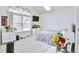 Bright bedroom with a window view, a mounted TV and light walls, creating a modern, airy feel at 1011 S Valentia St # 147, Denver, CO 80247