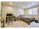 Neutral toned bedroom featuring a bed, desk, and natural light from the window, a comfortable space at 1011 S Valentia St # 147, Denver, CO 80247