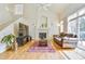 Bright living room featuring hardwood floors, fireplace, and a large window at 1011 S Valentia St # 147, Denver, CO 80247