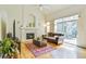 Bright living room with fireplace, hardwood floors, and sliding glass doors to the patio at 1011 S Valentia St # 147, Denver, CO 80247