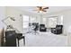 Bright living room with bay window, ceiling fan, piano, desk, and plush seating, perfect for relaxing and entertaining at 1011 S Valentia St # 147, Denver, CO 80247