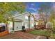 Charming backyard with a wooden deck, artificial grass, and mature trees at 4279 Brandon Ave, Broomfield, CO 80020