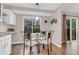 Cozy breakfast nook featuring a glass-top table, four chairs, and a view of the outdoor patio at 4279 Brandon Ave, Broomfield, CO 80020