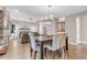 Open-concept dining area with views of the living room with hardwood floors and modern furnishings at 4279 Brandon Ave, Broomfield, CO 80020