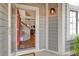 Inviting entryway featuring a bright red door, and showing the home's open staircase and interior living area at 4279 Brandon Ave, Broomfield, CO 80020