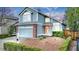Charming two-story home featuring a manicured lawn, brick accents, and an attached two-car garage at 4279 Brandon Ave, Broomfield, CO 80020
