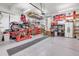 Spacious garage featuring workbench, ample storage, and a motorcycle lift at 4279 Brandon Ave, Broomfield, CO 80020
