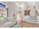 Bright living room with vaulted ceiling and staircase featuring hardwood floors and large windows at 4279 Brandon Ave, Broomfield, CO 80020