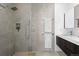 Contemporary bathroom with glass enclosed shower and gray tiled walls at 2150 S Delaware St, Denver, CO 80223