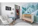 Charming Bedroom with crib, rocking chair, and themed wallpaper at 2150 S Delaware St, Denver, CO 80223