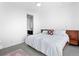 Bright bedroom features ceiling fan and a view into the en suite bathroom at 2150 S Delaware St, Denver, CO 80223