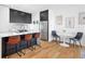 Modern kitchen and dining area with stainless appliances and barstool seating at 2150 S Delaware St, Denver, CO 80223