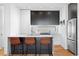 Sleek kitchen featuring stainless steel appliances, a breakfast bar, and modern cabinetry at 2150 S Delaware St, Denver, CO 80223