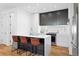 Well-equipped kitchen with stainless steel appliances, modern cabinets, and a breakfast bar at 2150 S Delaware St, Denver, CO 80223