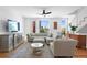 Bright living room featuring a comfortable sectional sofa, modern furnishings, and hardwood flooring at 2150 S Delaware St, Denver, CO 80223